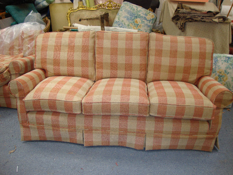Three-seater club style sofa in a coral check loose cover