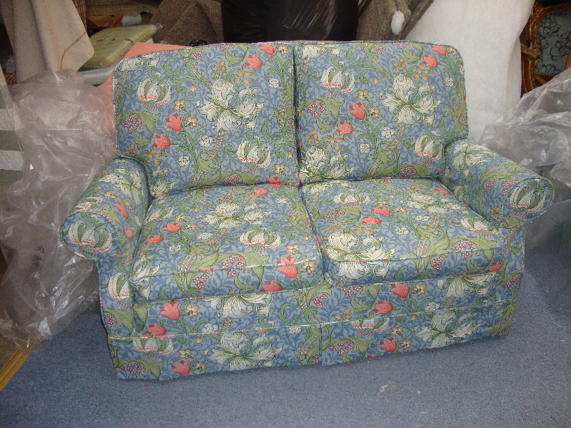 Two-seater sofa in a blue William Morris floral loose cover