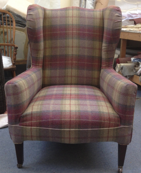 Wing chair in a purple and green plaid loose cover