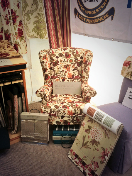 Parker Knoll wing chair in a floral print loose cover on our show stand