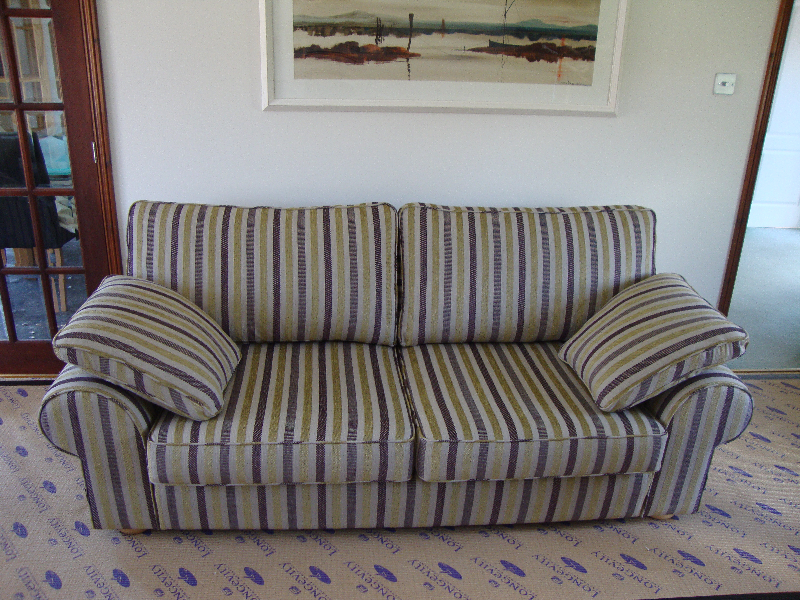 Striped sofa re-upholstered in green and grape tones