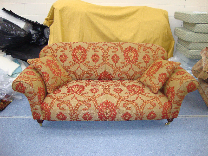 Two-seater sofa re-upholstered in a terracotta damask