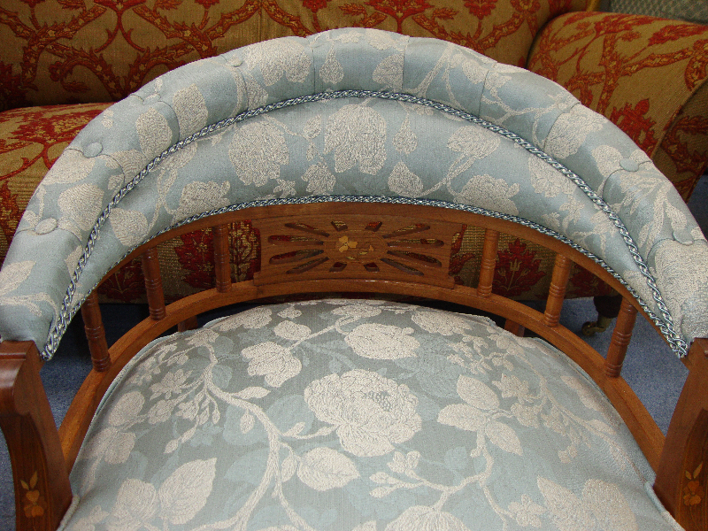 Close-up of the buttoned periwinkle back of the same tub chair