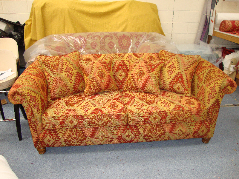 Sofa upholstered in a rich orange patterned fabric