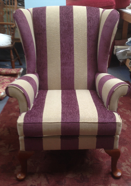 Parker Knoll wing chair re-upholstered in a wide purple and cream stripe